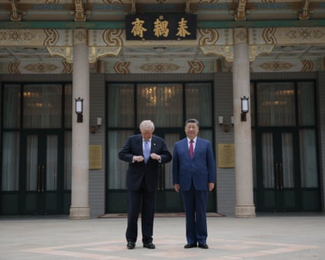 Donald Trump and Xi Jinping stand in front of an ornate building entrance
