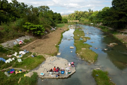 Women wash laundry along the Meille River, a tributary to the Artibonite River, the longest waterway in Haiti, which carried cholera through the country