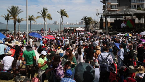 People gather and wait to observe a total solar eclipse in Mazatlán, Mexico.