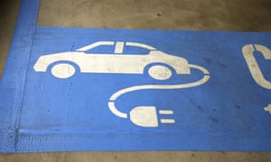 Signage for an electric car charging booth is displayed at Federation Square car park in Melbourne, Australia