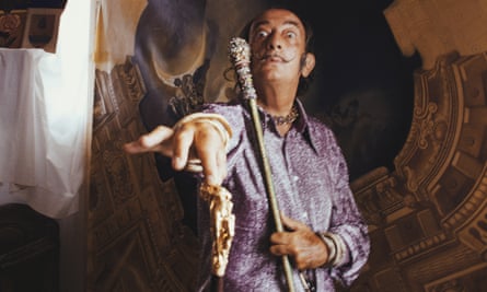 September 1970: With some of his works at Port Ligat, Costa Brava, painter Salvador Dali (1904 - 1989) in a characteristic pose with his trademark walking-stick
