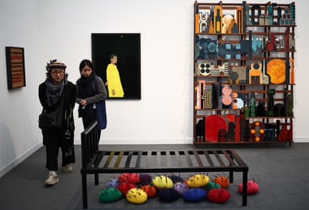 Visitors look at a work called Untitled – Bed by artist Permindar Kaur at Frieze London, 2025.