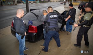 ICE officers detain a suspect as they conduct a targeted enforcement operation in Los Angeles.