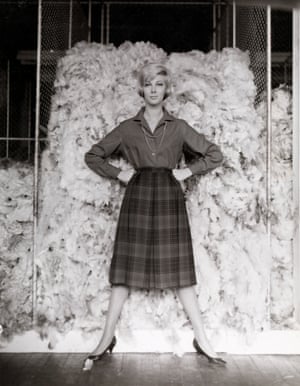Fashion illustration with model Janice Wakely in front of a wool bale (1961–66).