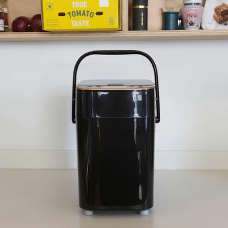 A black Panasonic bread maker with a handle and copper trim sits on a kitchen counter