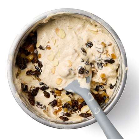 folding the fruit and nuts into the custard