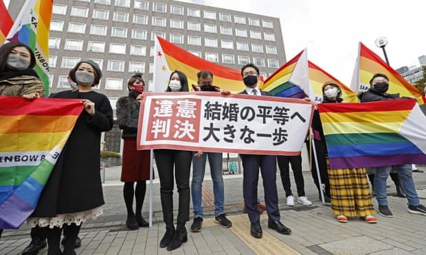 Plaintiffs' lawyers and supporters show a banner that reads 'Unconstitutional decision' after Sapporo district court ruled on the legality of same-sex marriages