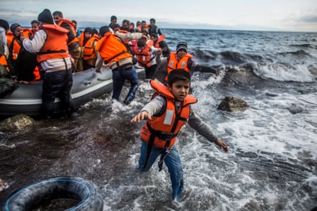 Refugees arrive on Lesbos after crossing the Aegean from Turkey on an inflatable boat