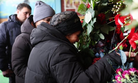 The mother of boxing coach and father Mykhailo Korenovsky grieves at his coffin.