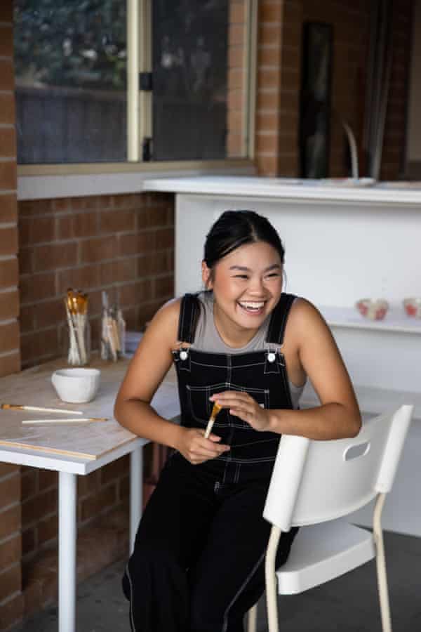 Li sits in her makeshift studio in western Sydney