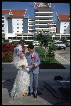 A newlywed couple pose outside the Hotel Cambodiana in Phnom Penh, Cambodia, 1970