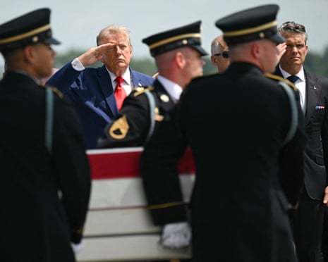 Donald Trump salutes during a dignified transfer for US service members killed during operations in the Middle East.