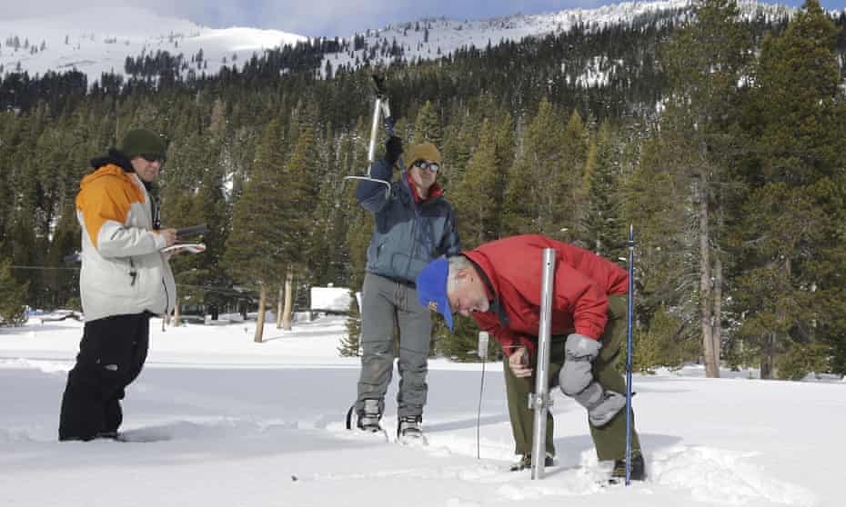 Frank Gehrke, right, chief of the California Cooperative Snow Surveys Program for the department of water resources, checks the snowpack depth near Echo Summit in the Sierra Nevada.