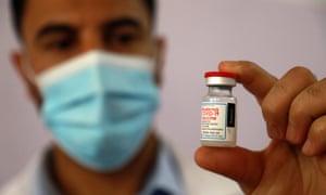 A medic prepares a dose of the Moderna coronavirus vaccine