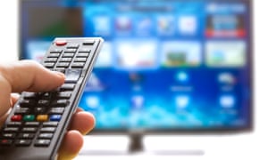 Television remote control changes channels thumb on the blue TV screen