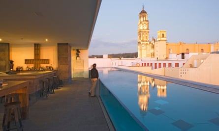 The roof terrace of the La Purificadora hotel has a view of Convento de San Francisco, in Puebla, Mexico