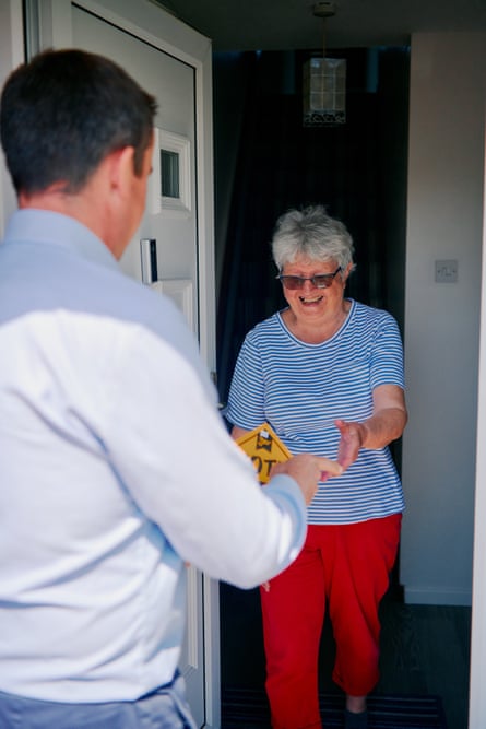 June Parry smiling while standing at her front door