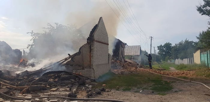 This picture taken and released by the Ukrainian emergency service shows firefighters working to put out a fire in a destroyed house after shelling in the Kharkiv region.