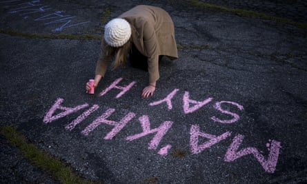 A woman writes Ma’Khia Bryant’s name in chalk in Columbus in April.
