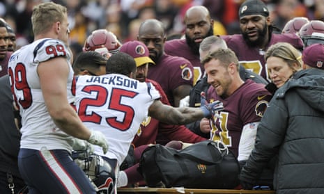 Alex Smith is comforted by teammates and opponents after his injury against the Houston Texans