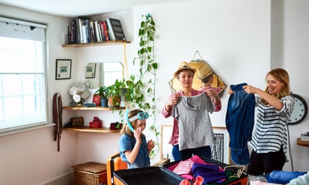 Same-sex couple packing for holiday with son and daughter.