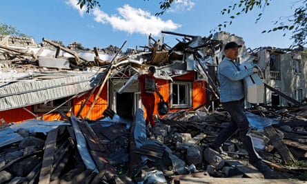 Men begin clearing up a building destroyed by recent shelling in the Luhansk region of Ukraine.