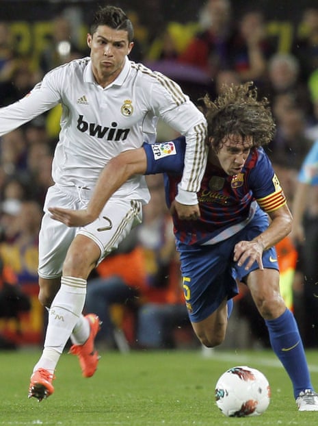 FC Barcelona's defender Carles Puyol, right, Real Madrid's Portuguese forward Cristiano Ronaldo on 21 April 2012.