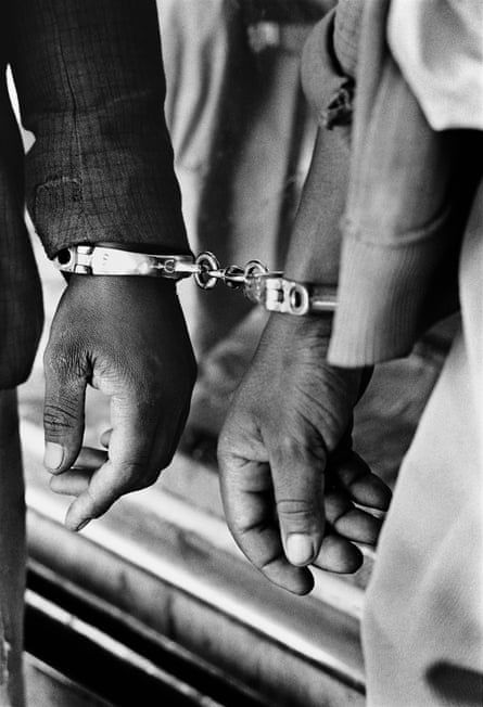 Handcuffed Black people arrested for being in a white area illegally in 1960s South Africa, from House of Bondage by Ernest Cole