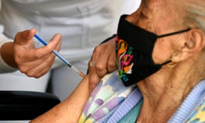 Vaccinating an elderly woman against coronavirus in Mexico City.