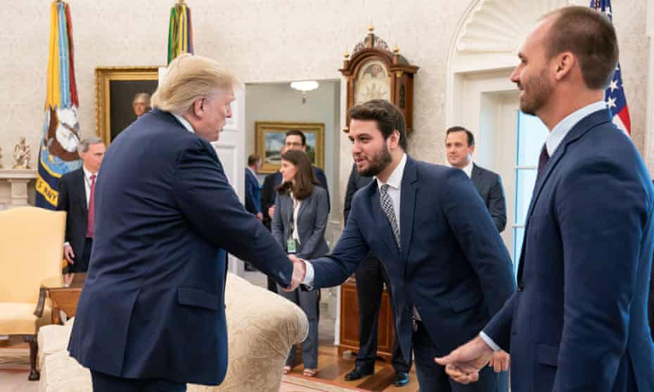 Filipe Martins, Jair Bolsonaro’s foreign policy adviser, shakes hands with Donald Trump in the Oval Office in Washington.