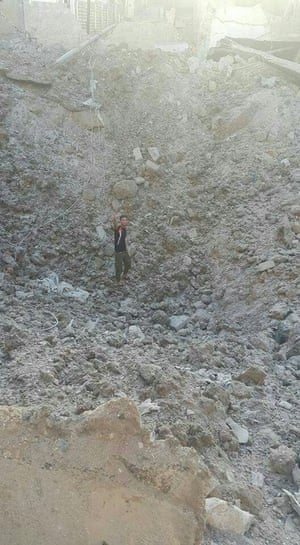 The crater left by the explosion of an alleged bunker-buster bomb in Tariq al Bab neighbourhood.
