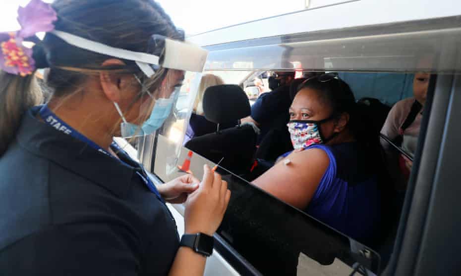 A member of the public receives a Pfizer vaccine at a drive-through coronavirus disease (COVID-19) vaccination clinic in Otara