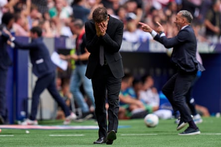 Diego Simeone hides his face after Atlético Madrid go 4-2 ahead of Real