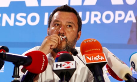 The far-right League party leader and Italy’s deputy prime minister, Matteo Salvini, kisses a crucifix