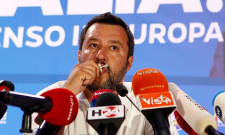 The League’s Matteo Salvini kisses a crucifix during the European election results announcement in Milan