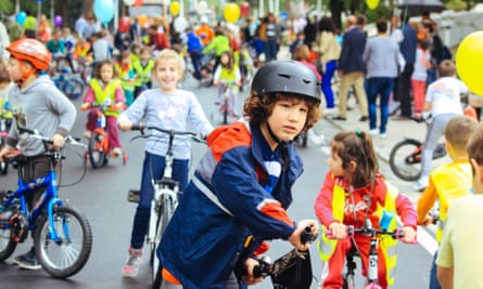 Children ride bikes on closed streets in Tirana.