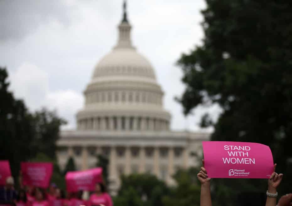 Women hold up signs during a pro-choice rally on Capitol Hill.