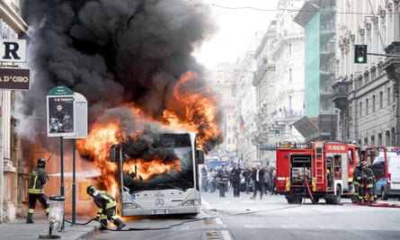 A bus is engulfed by flames in via del Tritone, in central Rome, May 2018.