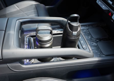 two water bottles in cup holders of car