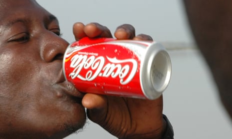 A man drinking a can of Coca-Cola