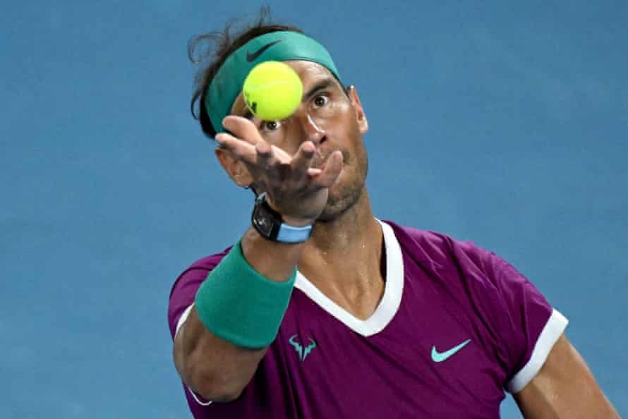 A focused Rafael Nadal serves.