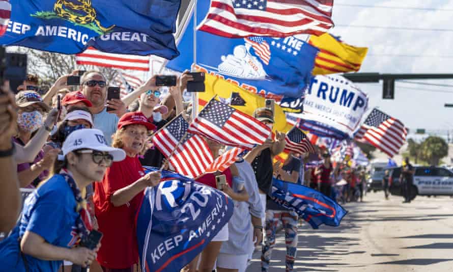 Supporters wait for Donald Trump to drive by in West Palm Beach, Florida on 15 February 2021.