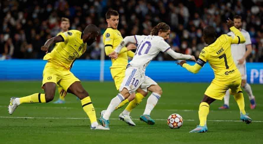 Luka Modric tries to pick a way through Chelsea. His perfect pass set up one of Real Madrid’s goals