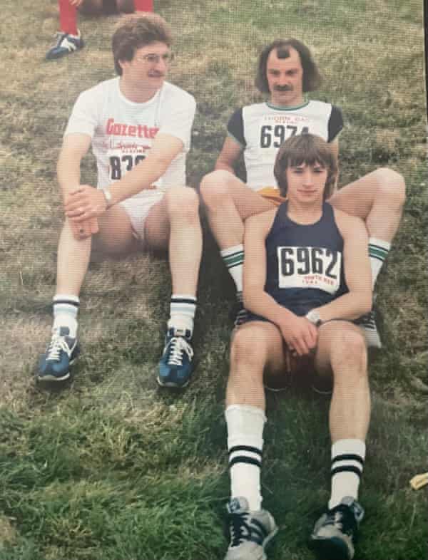 Ron Snaith (left) sits with Bob Hepburn (middle) on a grass bank by the start line of the first Great North Run in 1981