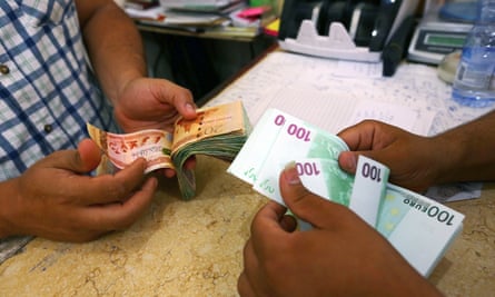 Currency is changed at a currency exchange in the Souk il-Jumaa district in Tripoli.