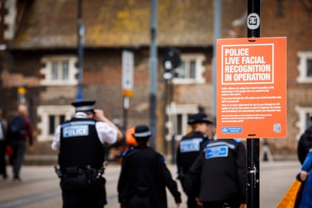 ‘Police live facial recognition in operation’, with several police officers in the background