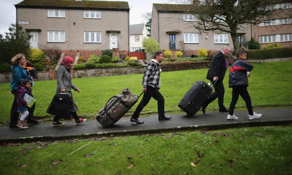 Syrian refugees arrive at their new homes on the Isle of Bute, Scotland, last December.
