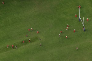 Schoolchildren playing on a rugby field.