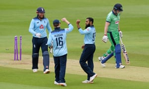 Ireland’s batsman Kevin O’Brien (right) walks back to the pavilion after getting bowled out by England’s Adil Rashid (second right) .