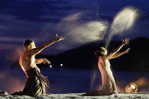 two dancers kneel as they perform